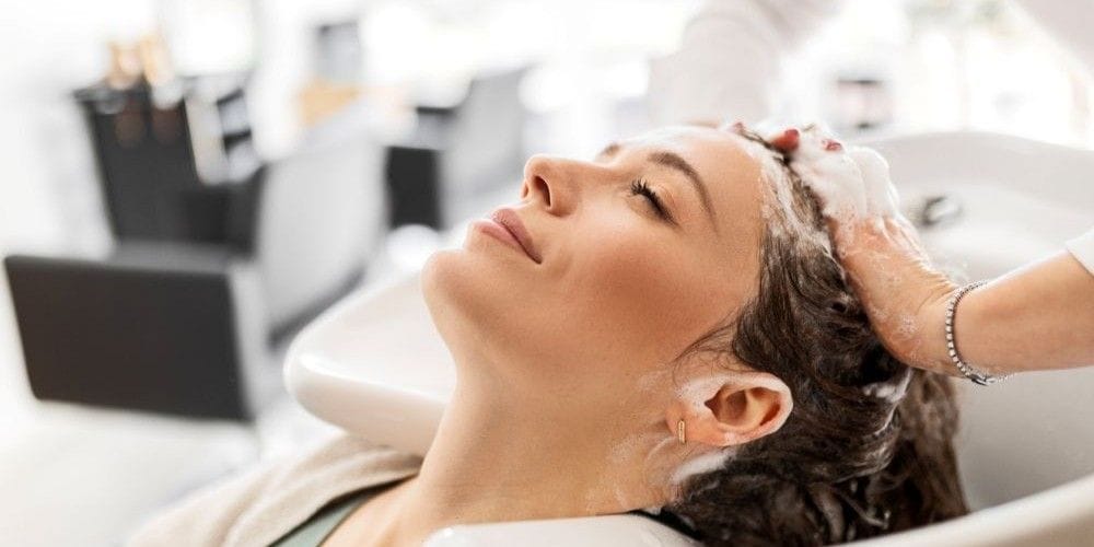 Woman getting her hair washed at the local hair salon.