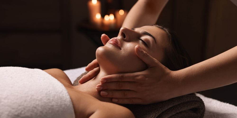 Woman receiving a face massage at a spa.